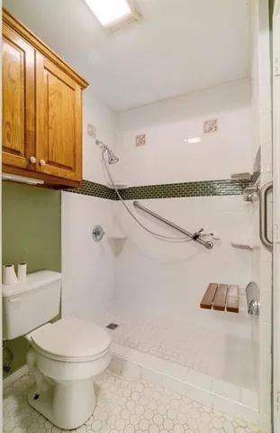 a bathroom with a toilet and a shower