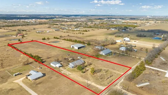 a dining room with furniture a chandelier and window
