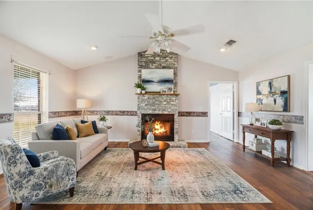 a bedroom with a bed lamps and a large window