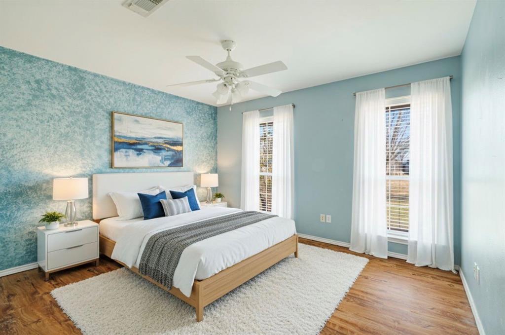 3754 County Road Paris, TX 75462 - Photo 31 of 33 a bedroom with a large bed and a chandelier