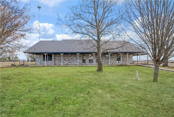 a view of house with a yard