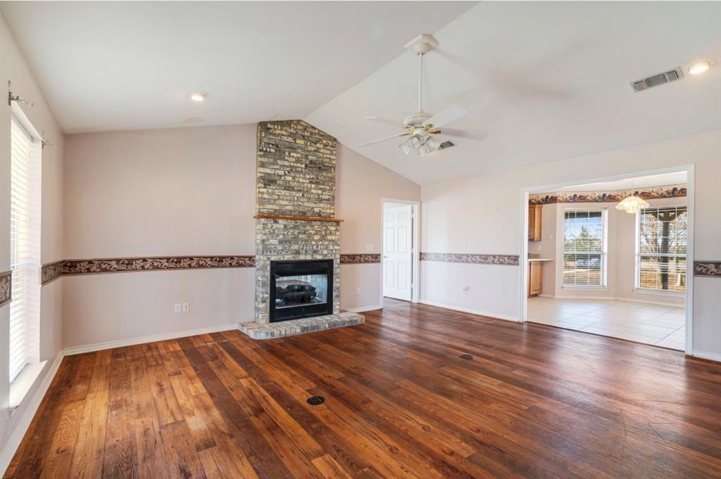 3754 County Road Paris, TX 75462 - Photo 6 of 33 a view of empty room with wooden floor and fireplace