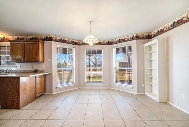 a view of an empty room with a kitchen