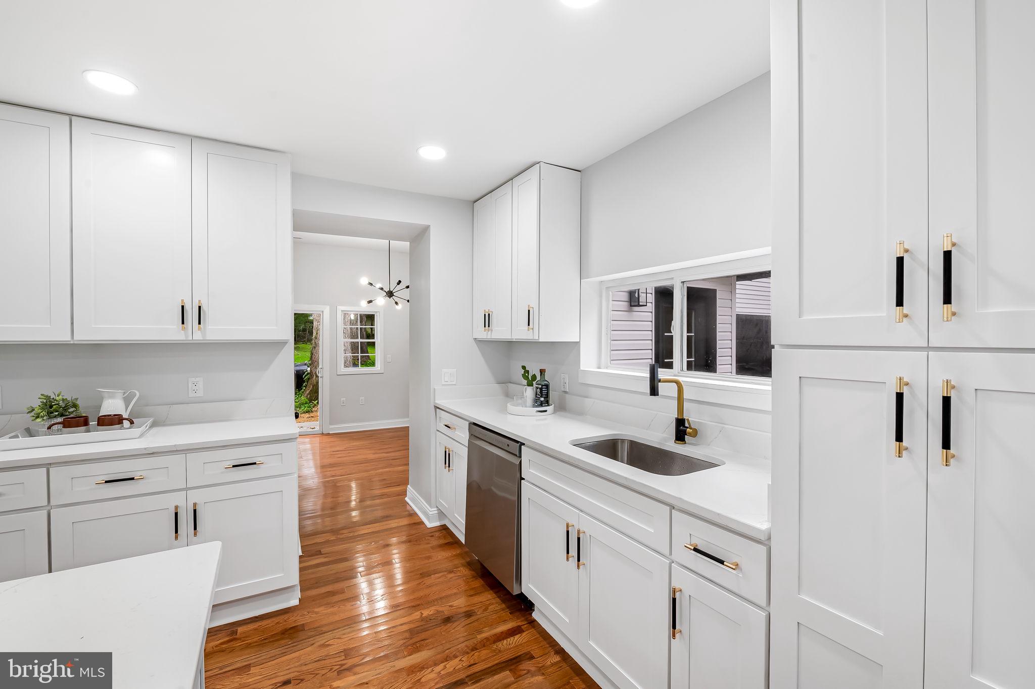6751 White Rock Road Sykesville, MD 21784 - Photo 13 of 44 a kitchen with white cabinets sink and white appliances
