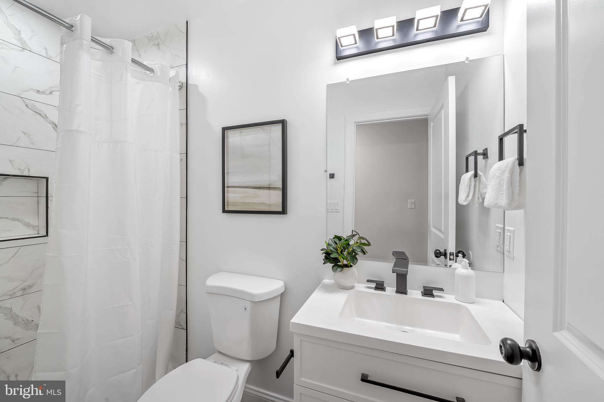 6751 White Rock Road Sykesville, MD 21784 - Photo 26 of 44 a bathroom with a sink toilet and shower