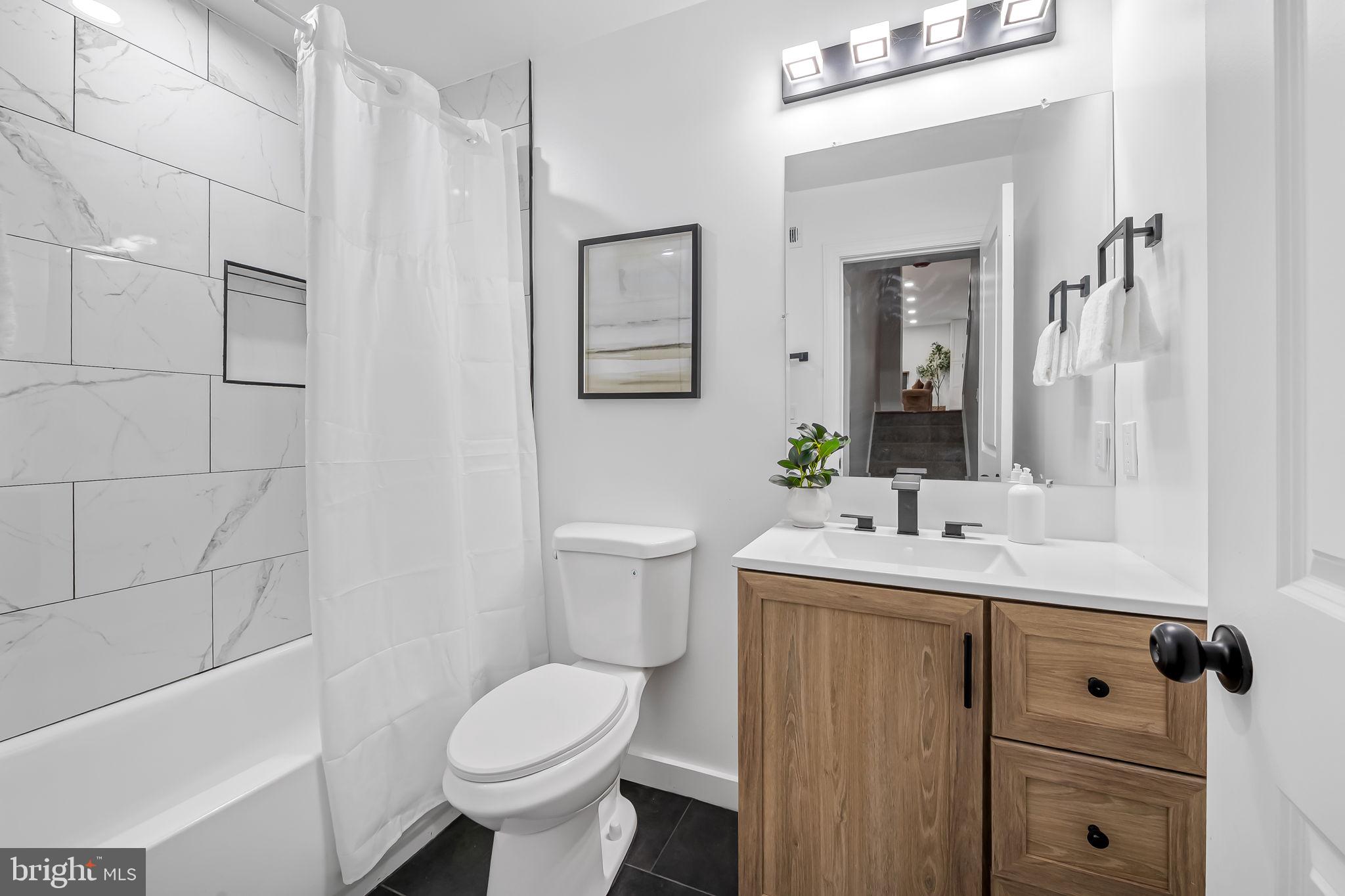 6751 White Rock Road Sykesville, MD 21784 - Photo 35 of 44 a bathroom with a toilet sink and mirror