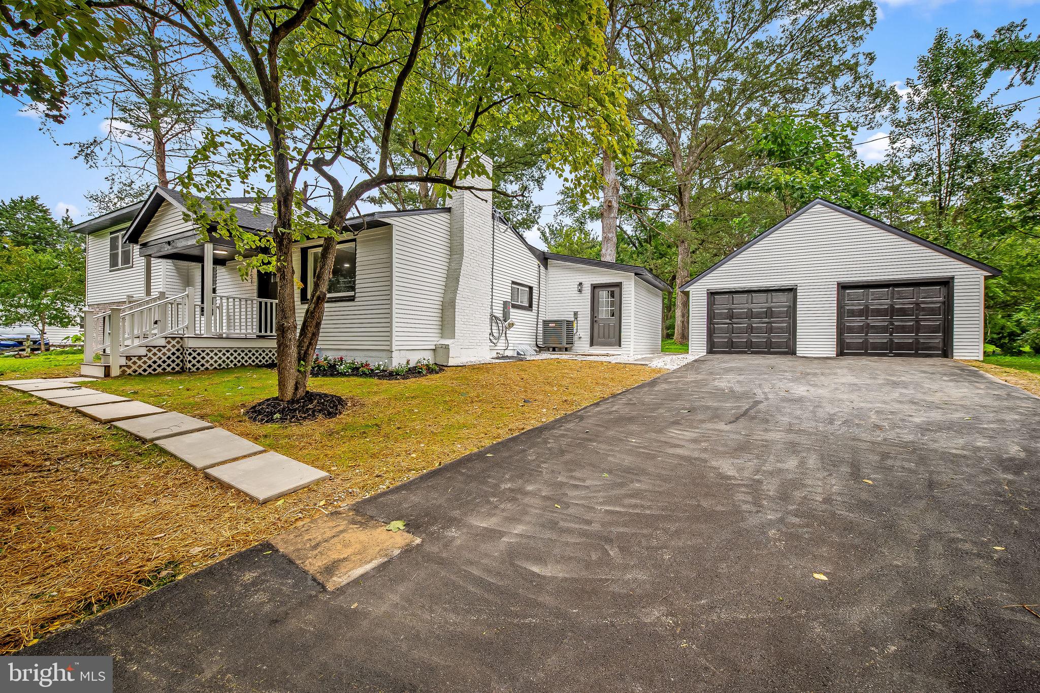 6751 White Rock Road Sykesville, MD 21784 - Photo 6 of 44 a front view of a house with a yard and garage