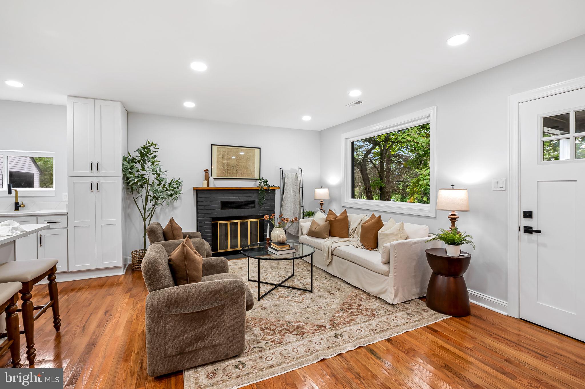 6751 White Rock Road Sykesville, MD 21784 - Photo 9 of 44 a living room with furniture a fireplace and a wooden floor