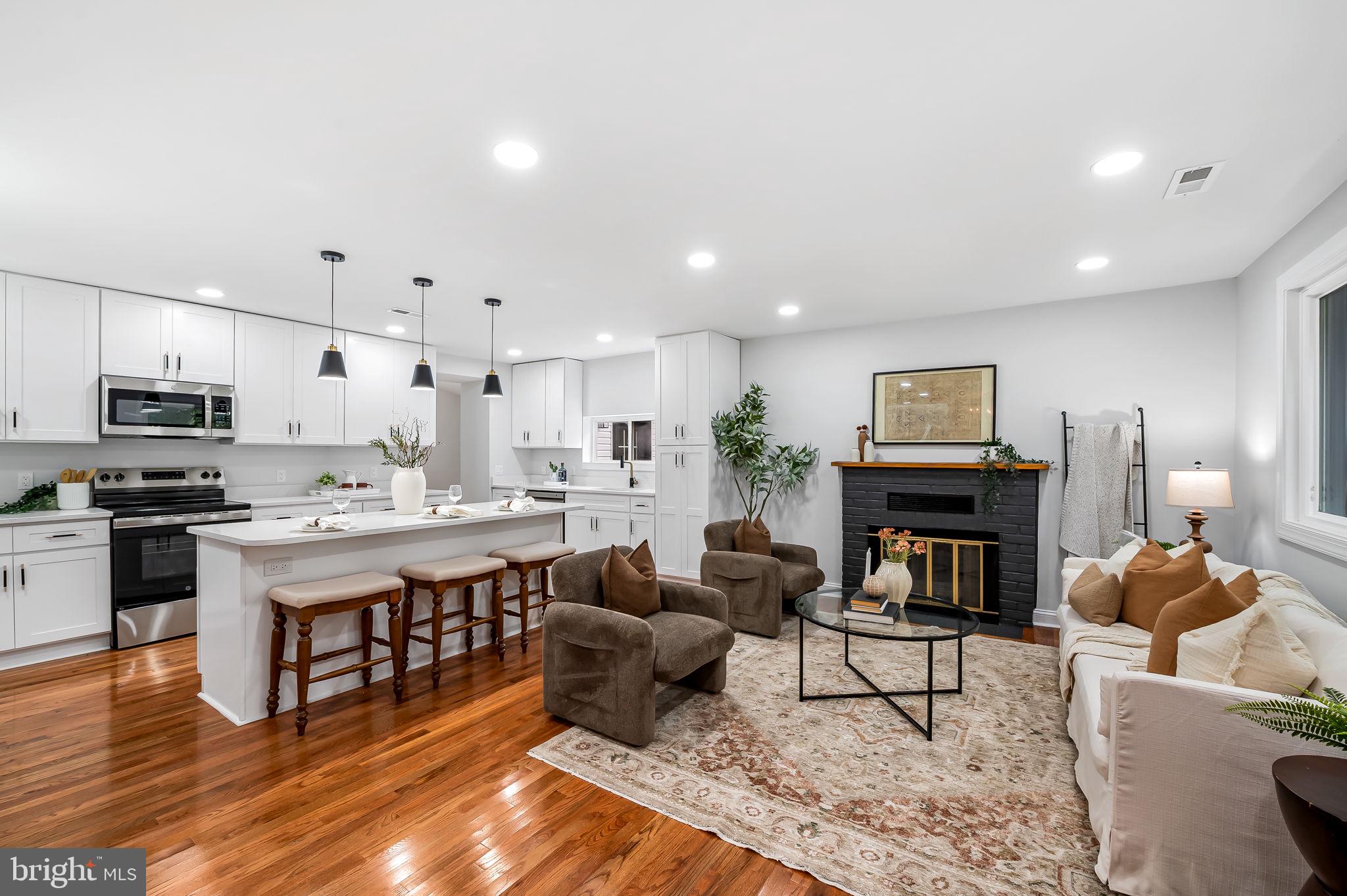 6751 White Rock Road Sykesville, MD 21784 - Photo 10 of 44 a living room with furniture a fireplace and kitchen view