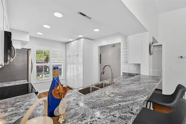 a kitchen with sink cabinets and microwave