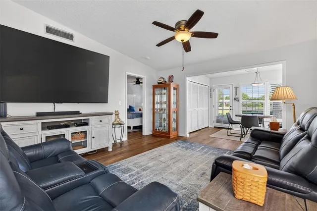 a dining room with furniture window and wooden floor