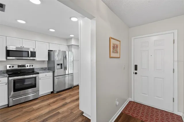 a kitchen with a sink stove and refrigerator