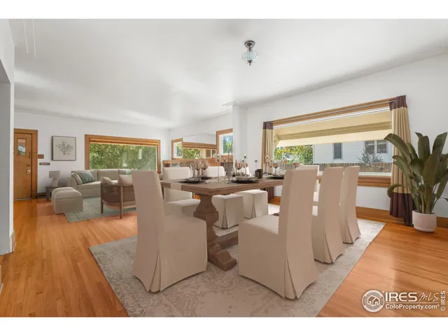 a living room with lots of furniture and a large window