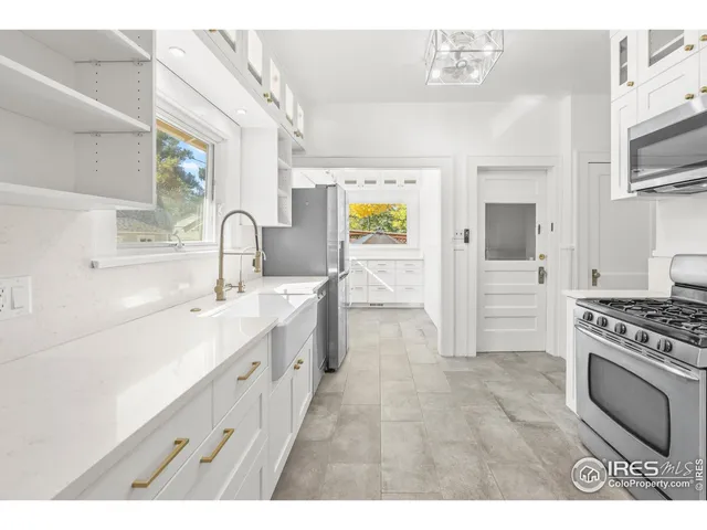 a kitchen with stainless steel appliances a sink stove and cabinets