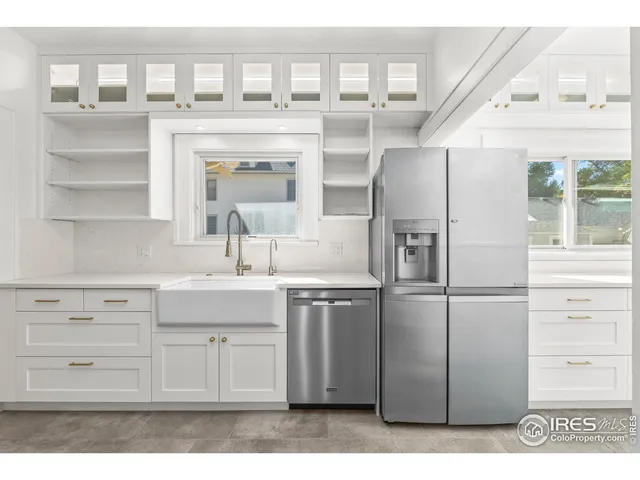 a kitchen with a refrigerator and a sink