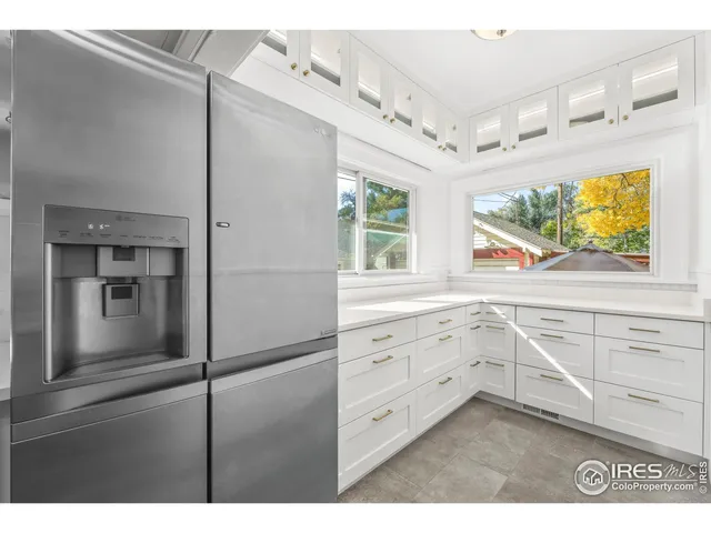 a kitchen with cabinets and window