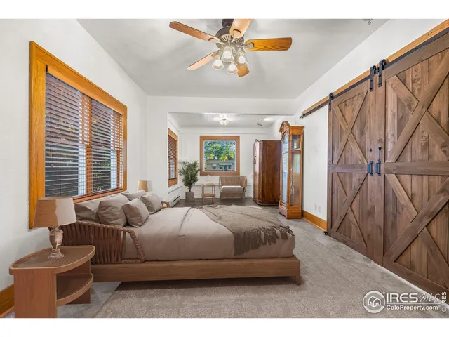 a bedroom with bed and window