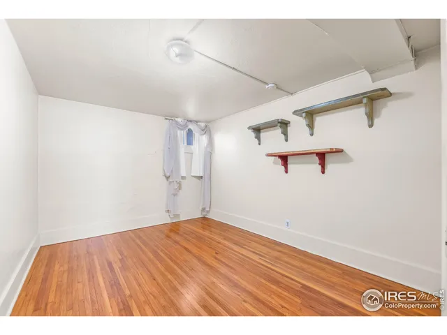 a view of a room with wooden floor