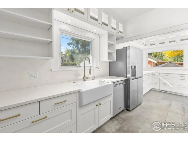 a kitchen with a sink cabinets and window