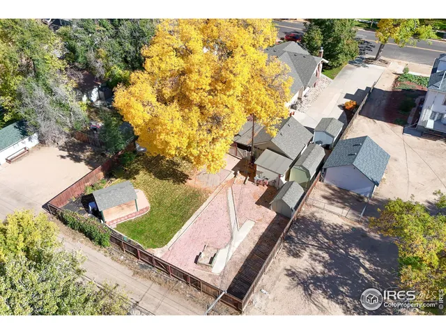 an aerial view of a house with a yard basket ball court and outdoor seating