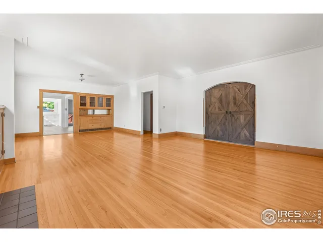 a view of an empty room and wooden floor