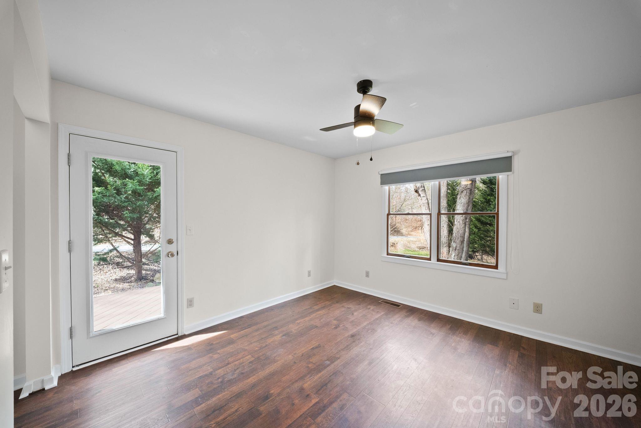 20 McDaris Road Weaverville, NC 28787 - Photo 10 of 15 a view of an empty room with a window and wooden floor