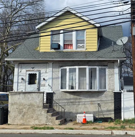 a front view of a house with large windows