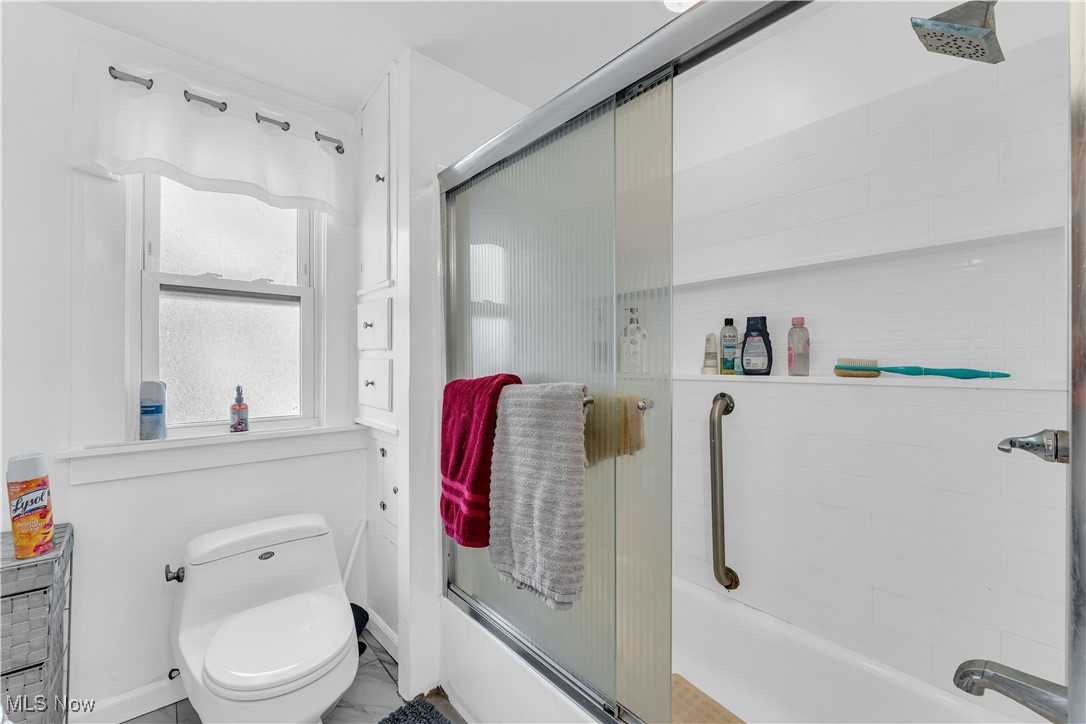 2123 North Taylor Road Cleveland Heights, OH 44112 - Photo 26 of 38 Bathroom featuring bath / shower combo with glass door and toilet