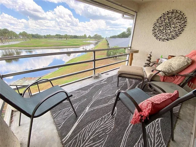 a view of a chairs and table in the balcony