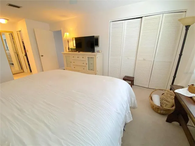 a walk in closet with wooden floor