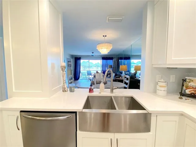 a kitchen with a sink a stove and cabinets