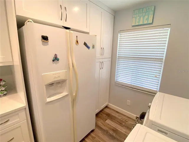 a view of a bedroom with wooden floor and windows