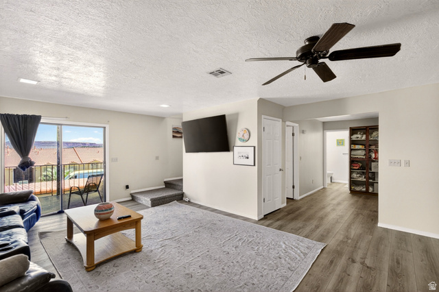 161 West 950 South, Unit Q1 St. George, UT 84770 - Photo 25 of 37 Living area with wood finished floors, a ceiling fan, and a textured ceiling