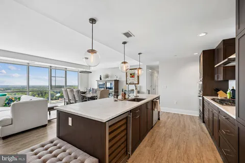 a living room with furniture and a flat screen tv with wooden floor
