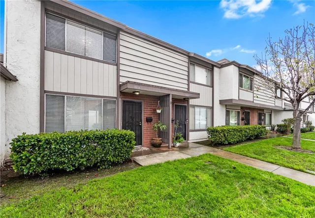 a view of a house with a yard and plants