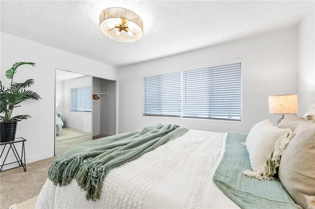 a bedroom with a bed and a lamp