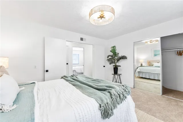 a bedroom with a bed and a large window