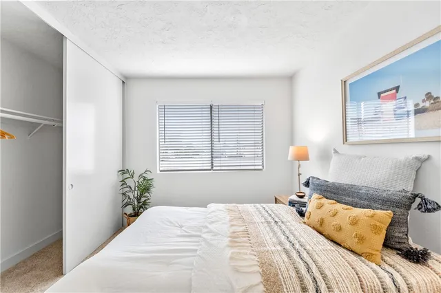 a bedroom with bed and a night stand