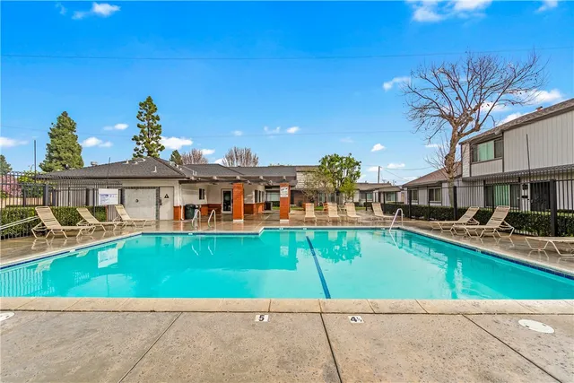 a house view with a swimming pool and sitting space