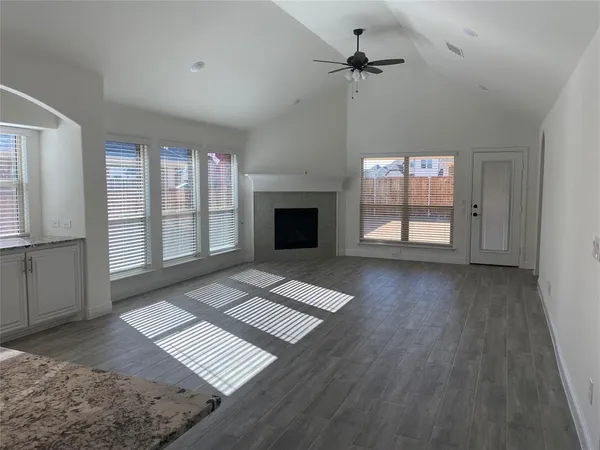 a view of an empty room with exposed radiator and fireplace
