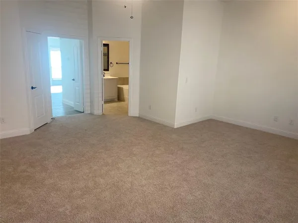 an empty room with an entrance to other room