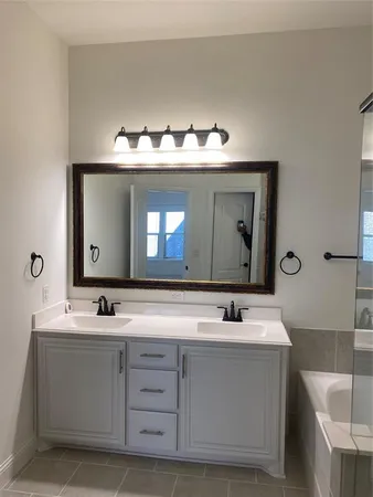 a bathroom with a sink vanity and a mirror