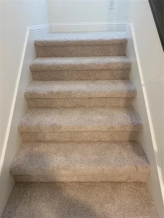 a view of staircase with white walls