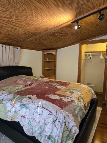 a bed sitting in a bedroom next to a window