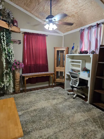 a view of a hallway with a dining area