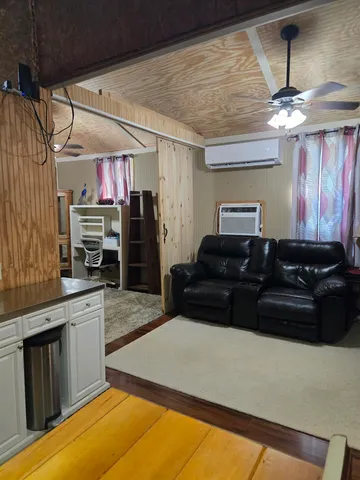 a living room with furniture and a piano