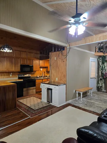 a kitchen with a sink and a stove top oven