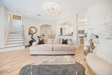 a living room with furniture and a large mirror