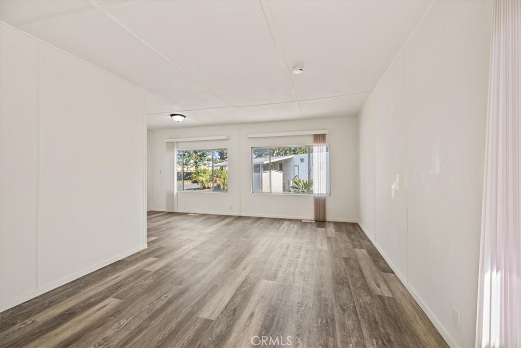 3210 Santa Maria Way, Unit 49 Santa Maria, CA 93455 - Photo 11 of 50 an empty room with wooden floor and windows