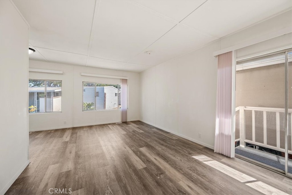 3210 Santa Maria Way, Unit 49 Santa Maria, CA 93455 - Photo 12 of 50 a view of an empty room with wooden floor and a window
